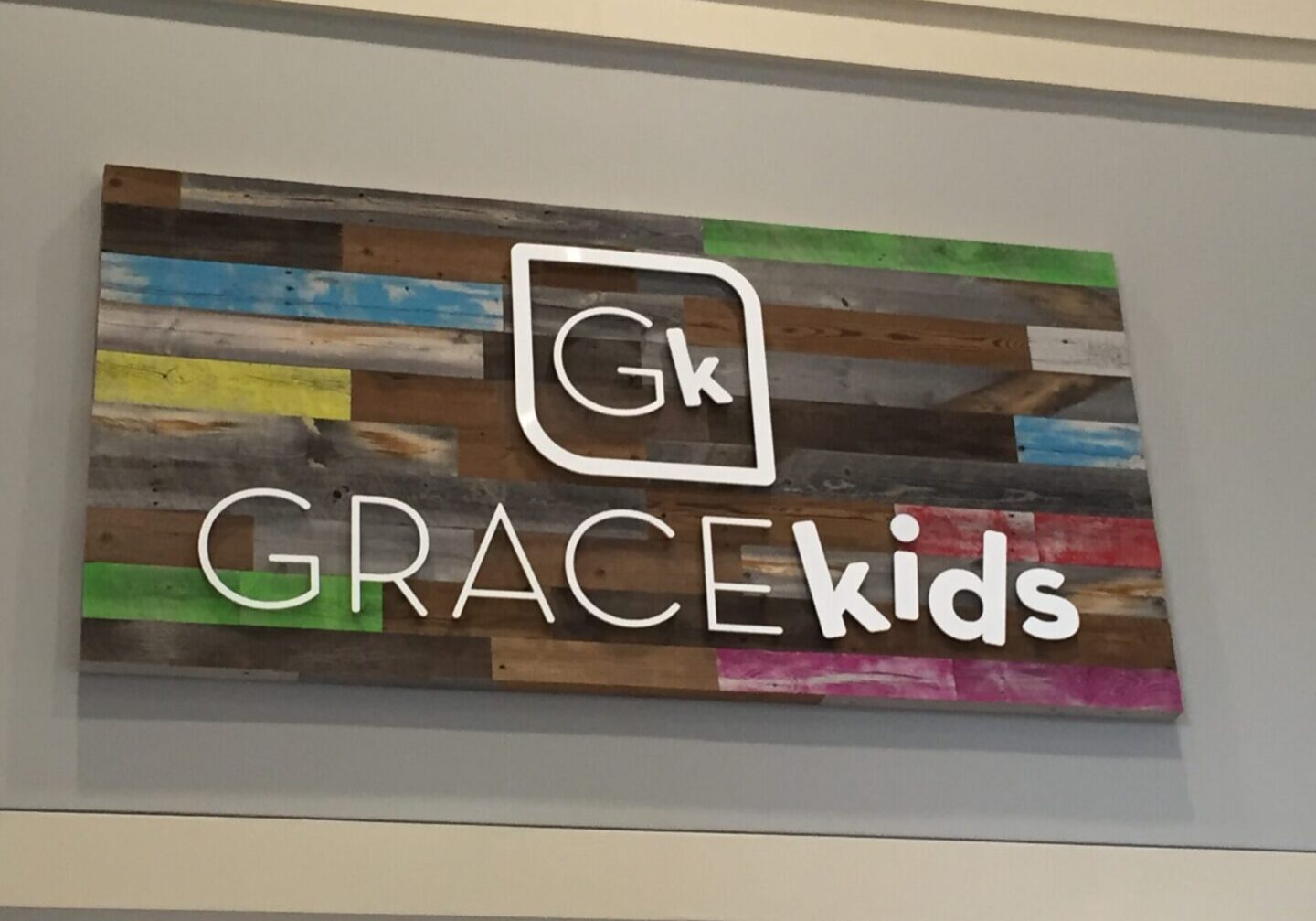 White Gk logo on multicolored GRACE kids panel
